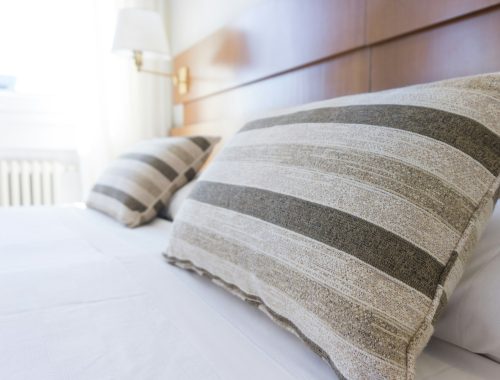 gray and black throw pillow on bed